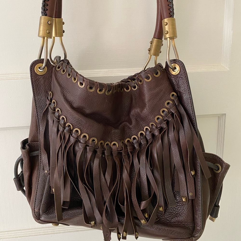 Michael Kors. Gorgeous boho bag with top quality leather and brass details.